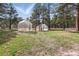 This backyard has two greenhouses, a picnic table, and lots of lawn with lots of open space for outdoor activities at 17720 Canterbury Dr, Monument, CO 80132