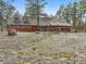 View of the backyard featuring a quaint windmill accent, native landscaping, and a charming wood fence at 17720 Canterbury Dr, Monument, CO 80132