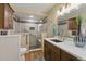Accessible bathroom with a tiled shower, grab bars, and wood cabinets at 17720 Canterbury Dr, Monument, CO 80132