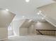 This bonus room offers recessed lighting, neutral colors, and staircase access, ideal for versatile living at 17720 Canterbury Dr, Monument, CO 80132