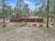 Aerial view of the home's exterior featuring a fenced in yard with mature trees at 17720 Canterbury Dr, Monument, CO 80132
