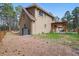 Beautiful home exterior with a cozy patio and a well-maintained lawn, complemented by mature trees at 17720 Canterbury Dr, Monument, CO 80132