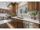 Modern kitchen with wood cabinets, stainless steel appliances, and a bright window at 17720 Canterbury Dr, Monument, CO 80132
