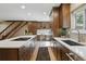 Open kitchen layout with white countertops, wooden cabinets, and stainless steel appliances at 17720 Canterbury Dr, Monument, CO 80132