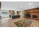 Spacious living room with modern kitchen and brick fireplace at 17720 Canterbury Dr, Monument, CO 80132
