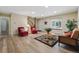 Inviting living room with wood floors, a large window, and a staircase at 17720 Canterbury Dr, Monument, CO 80132