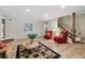 Well lit living room showcasing an open staircase and wood floors at 17720 Canterbury Dr, Monument, CO 80132