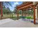 Inviting patio area with a pergola and string lights, perfect for outdoor dining and relaxation at 17720 Canterbury Dr, Monument, CO 80132