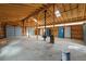 Large shop space with high ceilings, exposed beams, and multiple storage cabinets, ideal for projects at 17720 Canterbury Dr, Monument, CO 80132