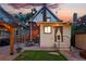 Charming backyard showcasing a quaint home, outdoor seating, lush lawn, and ambient string lights at 3008 N York St, Denver, CO 80205