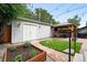 Spacious backyard showcasing a gazebo, lush lawn, garden beds, and ambient string lights at 3008 N York St, Denver, CO 80205