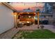 Inviting backyard with a cozy gazebo, comfortable seating, and a warm fire pit at sunset at 3008 N York St, Denver, CO 80205