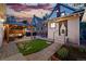 Beautiful backyard with a gazebo, outdoor seating, lush lawn, and ambient string lights at dusk at 3008 N York St, Denver, CO 80205