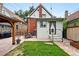 Charming backyard featuring a stone patio, small grassy area, and access to the back of the home at 3008 N York St, Denver, CO 80205