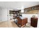 A finished basement office space features a built-in shelving unit and hardwood accent wall at 3008 N York St, Denver, CO 80205