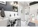 This bathroom features a glass shower, stylish vanity, and decorative black and white floor tile at 3008 N York St, Denver, CO 80205
