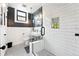 Modern bathroom featuring glass shower, white subway tile, and decorative black and white floor tile at 3008 N York St, Denver, CO 80205