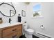 Stylish bathroom with a modern vanity, round mirror, and a clean, minimalist design at 3008 N York St, Denver, CO 80205