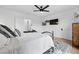 This bedroom boasts white walls, a stylish ceiling fan, and a flatscreen TV for relaxation at 3008 N York St, Denver, CO 80205