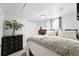 A stylish bedroom with a patterned comforter, plush pillows, and white walls at 3008 N York St, Denver, CO 80205