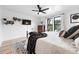 Bright bedroom features a ceiling fan, flatscreen TV, and large window with exterior views at 3008 N York St, Denver, CO 80205