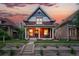 Charming home with a covered porch and a beautifully landscaped front yard at sunset at 3008 N York St, Denver, CO 80205