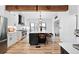 Spacious kitchen with stainless appliances, island with seating, and modern design elements at 3008 N York St, Denver, CO 80205