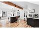 Bright kitchen featuring a large island, wood beam, and stylish cabinetry at 3008 N York St, Denver, CO 80205