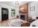 Inviting living room showcasing a brick fireplace, hardwood floors, and modern accents at 3008 N York St, Denver, CO 80205