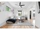 Bright living room with modern furniture, a ceiling fan, and natural light from large windows at 3008 N York St, Denver, CO 80205