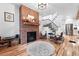 Cozy living room with a brick fireplace, hardwood floors, and stylish furnishings at 3008 N York St, Denver, CO 80205