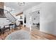 Bright living room with hardwood floors leads into the kitchen and a separate sitting area at 3008 N York St, Denver, CO 80205