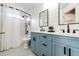 Stylish bathroom features a blue vanity, shiplap walls, and modern black fixtures at 4157 Astrion Ct, Castle Rock, CO 80104