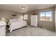 Comfortable bedroom with a queen bed, white armoire, two windows, and neutral décor creating a relaxing and inviting atmosphere at 4157 Astrion Ct, Castle Rock, CO 80104