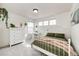 Airy bedroom features natural light, white furniture, and soft, neutral accents at 4157 Astrion Ct, Castle Rock, CO 80104