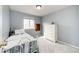 Small, cozy bedroom with a single bed, dresser, and window offers a comfortable and private space with soft lighting at 4157 Astrion Ct, Castle Rock, CO 80104