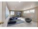 Finished basement featuring a blue sectional sofa and a gaming setup for entertainment, creating a comfortable and versatile space at 4157 Astrion Ct, Castle Rock, CO 80104