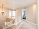 Upstairs hallway with railing and chandelier leads to bedrooms with carpeted floors and a view of the staircase below at 4157 Astrion Ct, Castle Rock, CO 80104