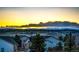 Scenic view of the neighborhood with mountains visible in the distance at sunset at 4157 Astrion Ct, Castle Rock, CO 80104