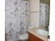 Charming bathroom with Paris-themed shower curtain, ceramic tile countertop, and modern sink at 6368 S Walden Way, Aurora, CO 80016