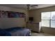 Sunlit bedroom featuring a ceiling fan, window, and a dresser for ample storage solutions at 6368 S Walden Way, Aurora, CO 80016