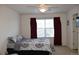 Cozy bedroom with a ceiling fan, large window with curtains, and carpeted floors at 6368 S Walden Way, Aurora, CO 80016
