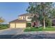 Inviting two-story home featuring a three-car garage, manicured lawn, and mature trees in a suburban setting at 6368 S Walden Way, Aurora, CO 80016