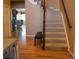 Open foyer with hardwood floors, carpeted stairs, and a view into the living spaces beyond at 6368 S Walden Way, Aurora, CO 80016