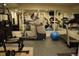 Well-equipped home gym featuring a treadmill, elliptical, weight machine, and mirrored walls at 6368 S Walden Way, Aurora, CO 80016