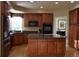 Bright kitchen boasts wood floors, granite counters, stainless appliances, central island and plenty of cabinets at 6368 S Walden Way, Aurora, CO 80016