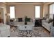 Inviting living room with a decorative rug, neutral furniture, and plenty of natural light from large windows at 6368 S Walden Way, Aurora, CO 80016