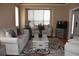 Cozy living room with neutral decor, plush seating, an area rug, and plenty of natural light at 6368 S Walden Way, Aurora, CO 80016