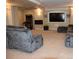 Spacious living room featuring plush seating, a fireplace, and an arcade game at 6368 S Walden Way, Aurora, CO 80016