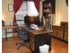 Home office featuring hardwood floors, a large desk with monitors, and a bookcase at 6368 S Walden Way, Aurora, CO 80016